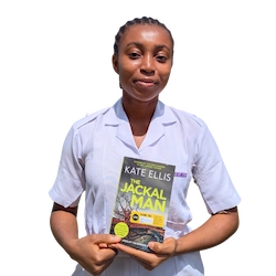 nursing student holding a book donated by books2africa