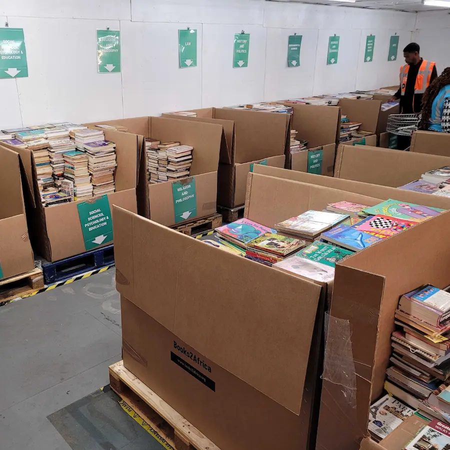 Cartons of donated books sorted by category, ready to be packed